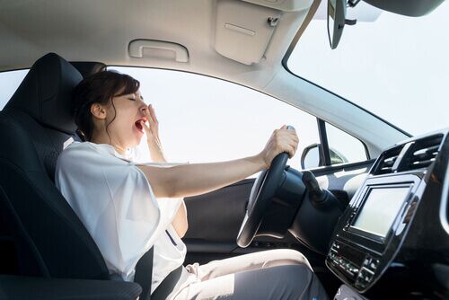 fatigued driver yawning while driving