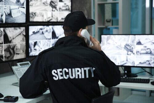 security on phone looking at monitors