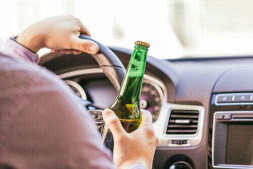 person drinking while driving