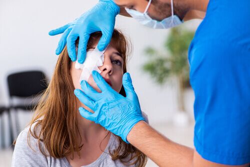 person with facial injury scar under bandage